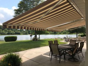 Striped Awning With Table And Chairs